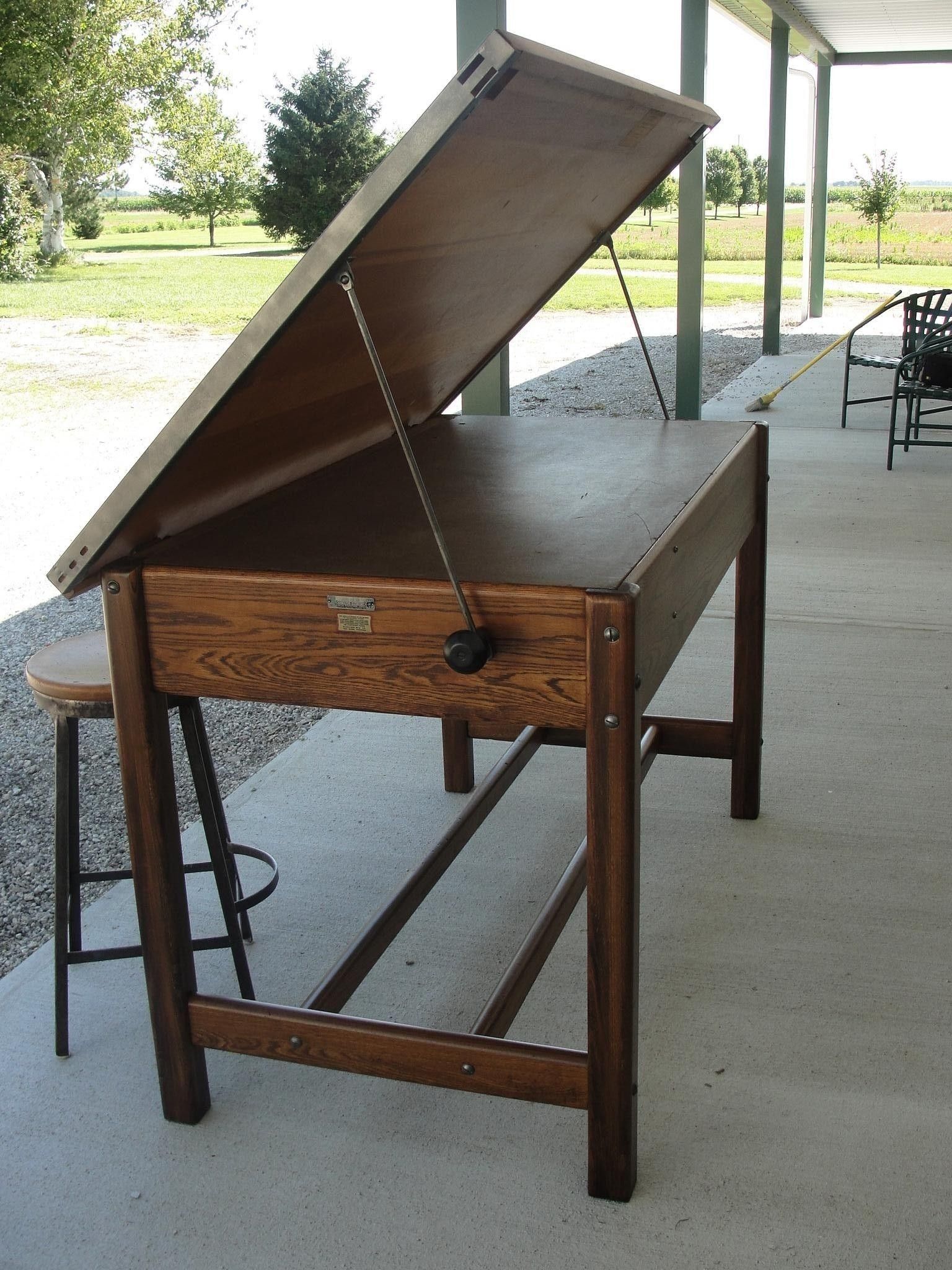 Modern architecture office workspace with drafting desks and plans